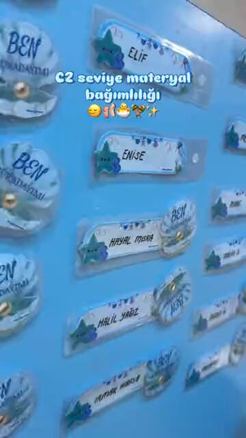 Handwritten name labels pinned in rows across a classroom board