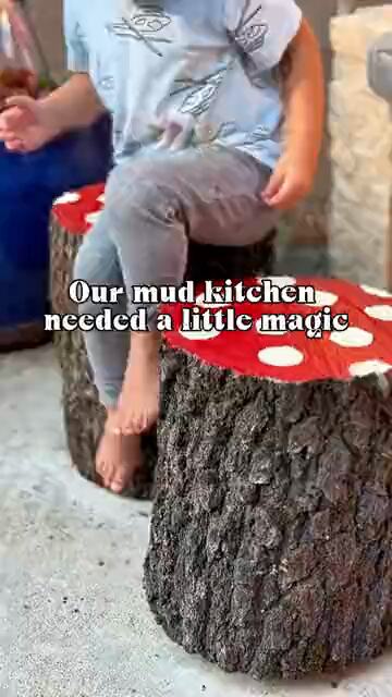 A child painting a wood stump red to turn it into a toadstool seat
