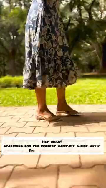 Someone walking a paved path in a long floral skirt